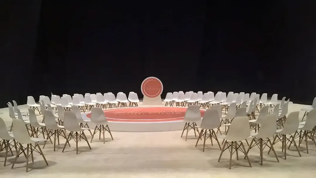 Youth sustainability discussion forum with modular seating circle and branded backdrop in Abu Dhabi