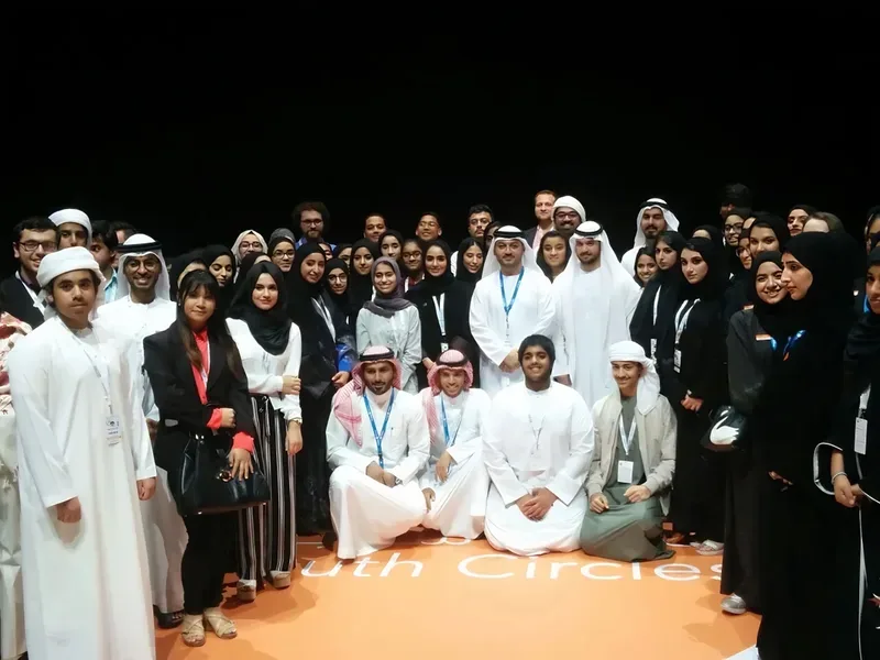 Wide-angle shot of Abu Dhabi youth forum hall filled with students and environmental advocates