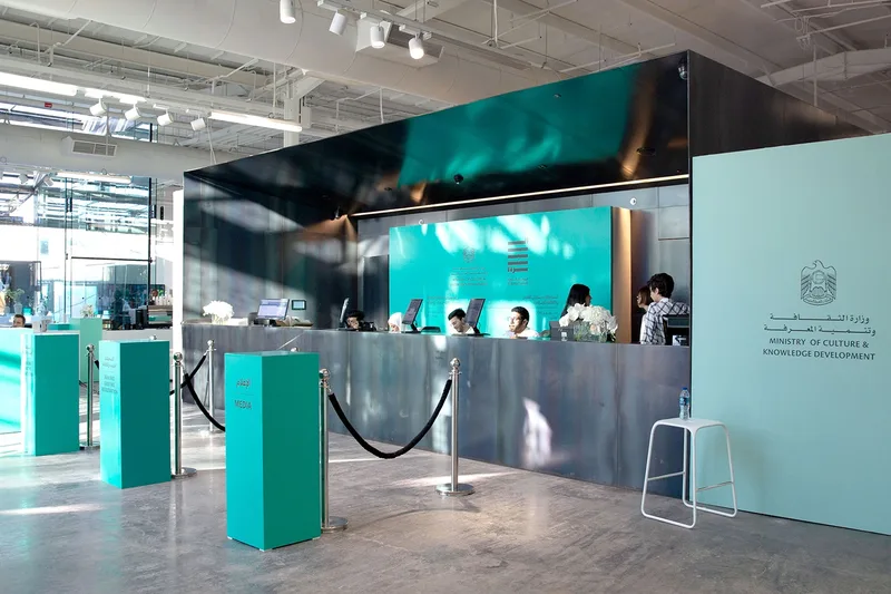Sleek registration desks featuring laser-cut geometric wooden fronts in Abu Dhabi