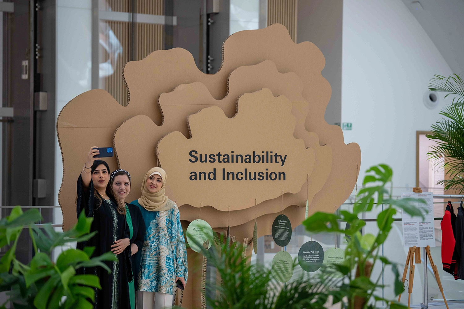 Guests taking a selfie beside the Sustainability and Inclusion installation at Museum of the Future