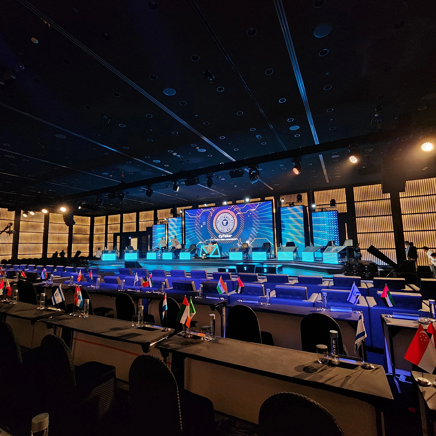 Evolution Technical dynamic lighting rig illuminating arena stage with dramatic blue and purple spotlights