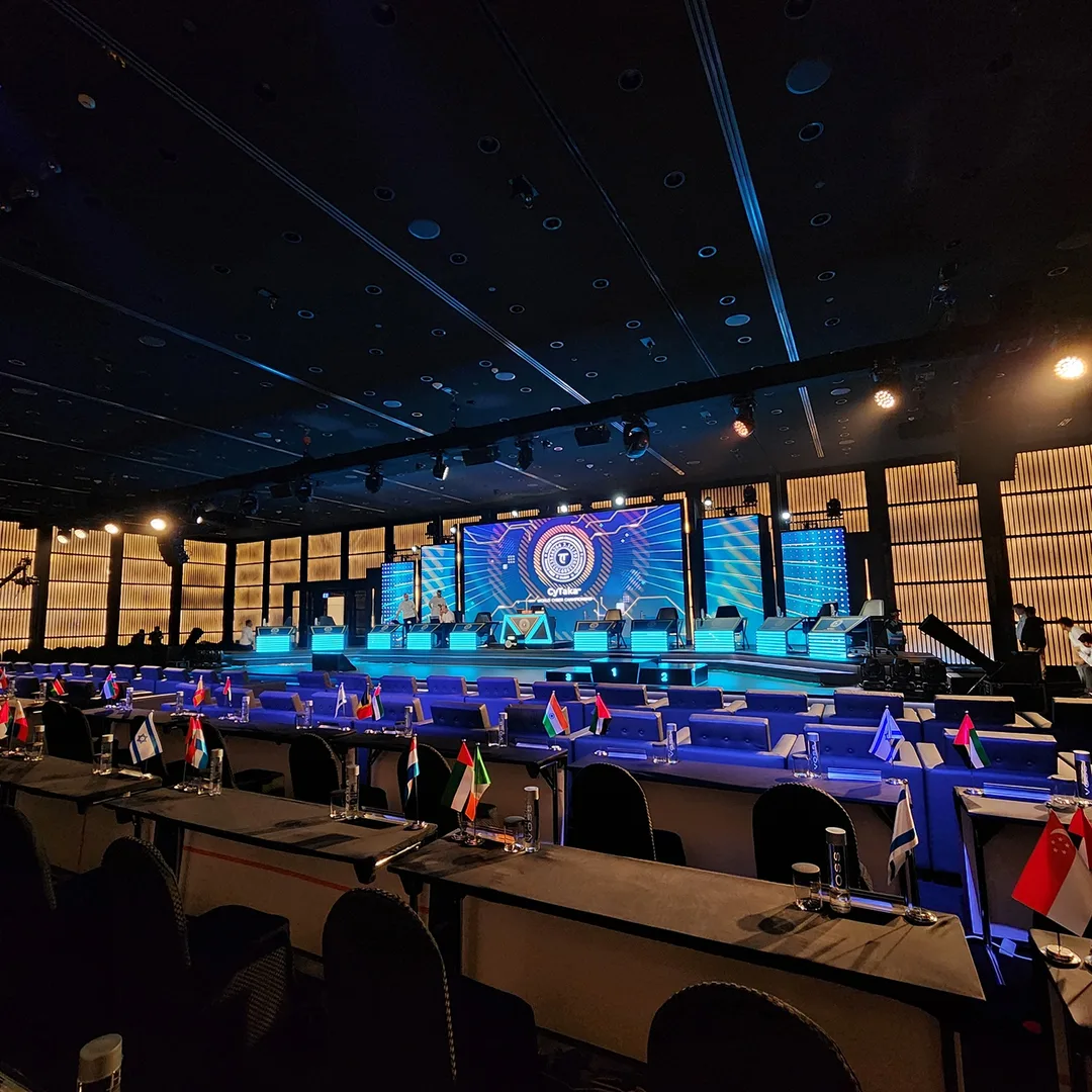 Evolution Technical dynamic lighting rig illuminating arena stage with dramatic blue and purple spotlights