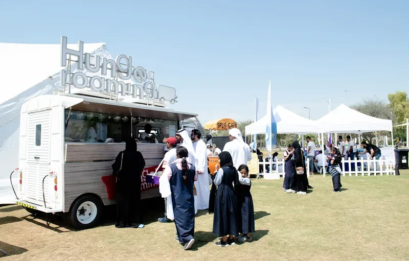 Catering food park with shaded family picnic benches and healthy snack service counters