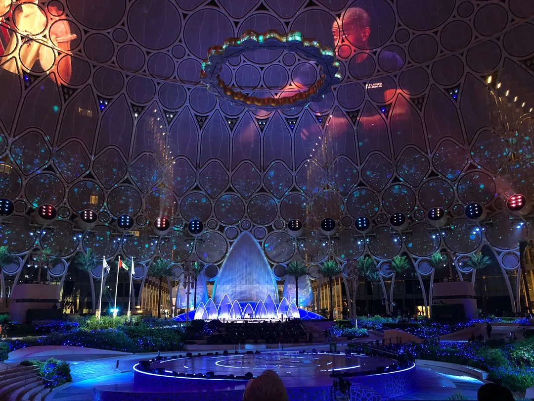 Al Wasl Dome illuminated with 360-degree projection mapping during grand opening ceremony.