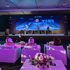 Global Citizen Forum gala dinner with guests seated at formal banquet tables under purple event lighting.