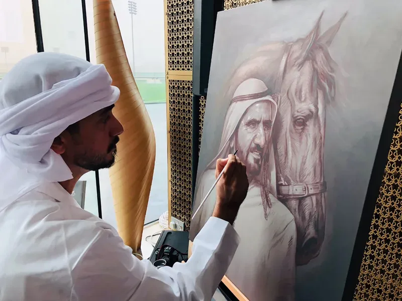 Emirati artist creating a live portrait of a man beside an Arabian horse at the For the Love of Horses exhibition
