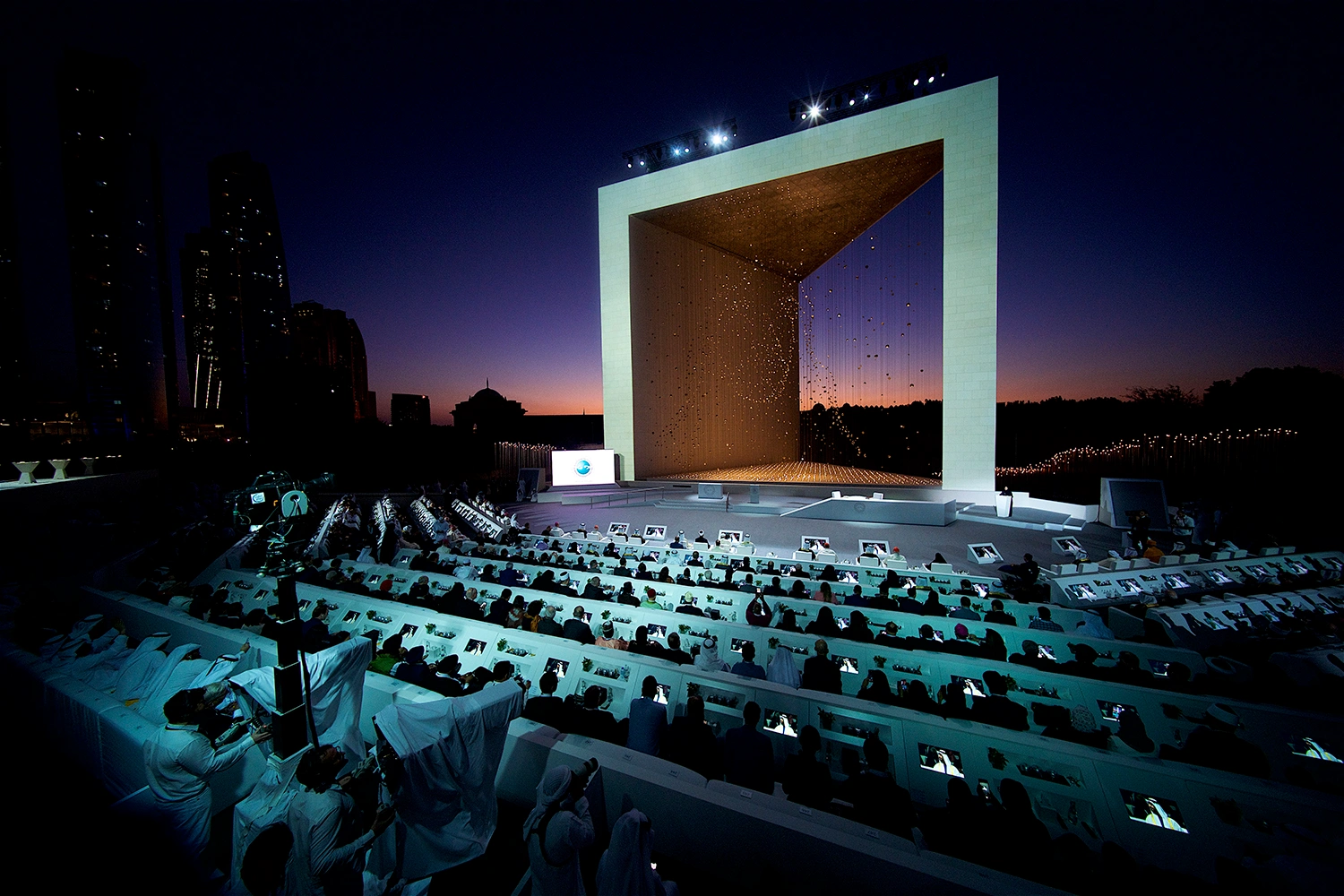 Founder's Memorial launch majlis with mashrabiya-inspired panels, large Sheikh Zayed photographs and custom white furniture.