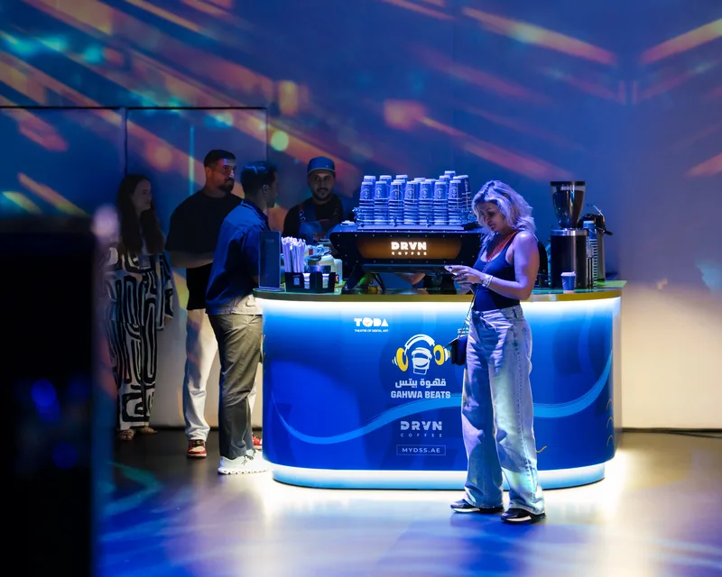 DRVN Coffee pop-up bar featuring custom illuminated blue counter and espresso machine in Dubai