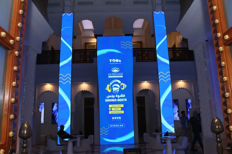 Vertical LED digital screen displays inside grand entrance foyer welcoming guests at TODA Souk Madinat