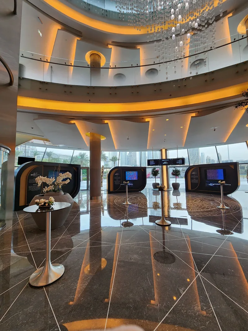 HIPA Diversity exhibition displays with integrated screens and elegant floral hospitality tables