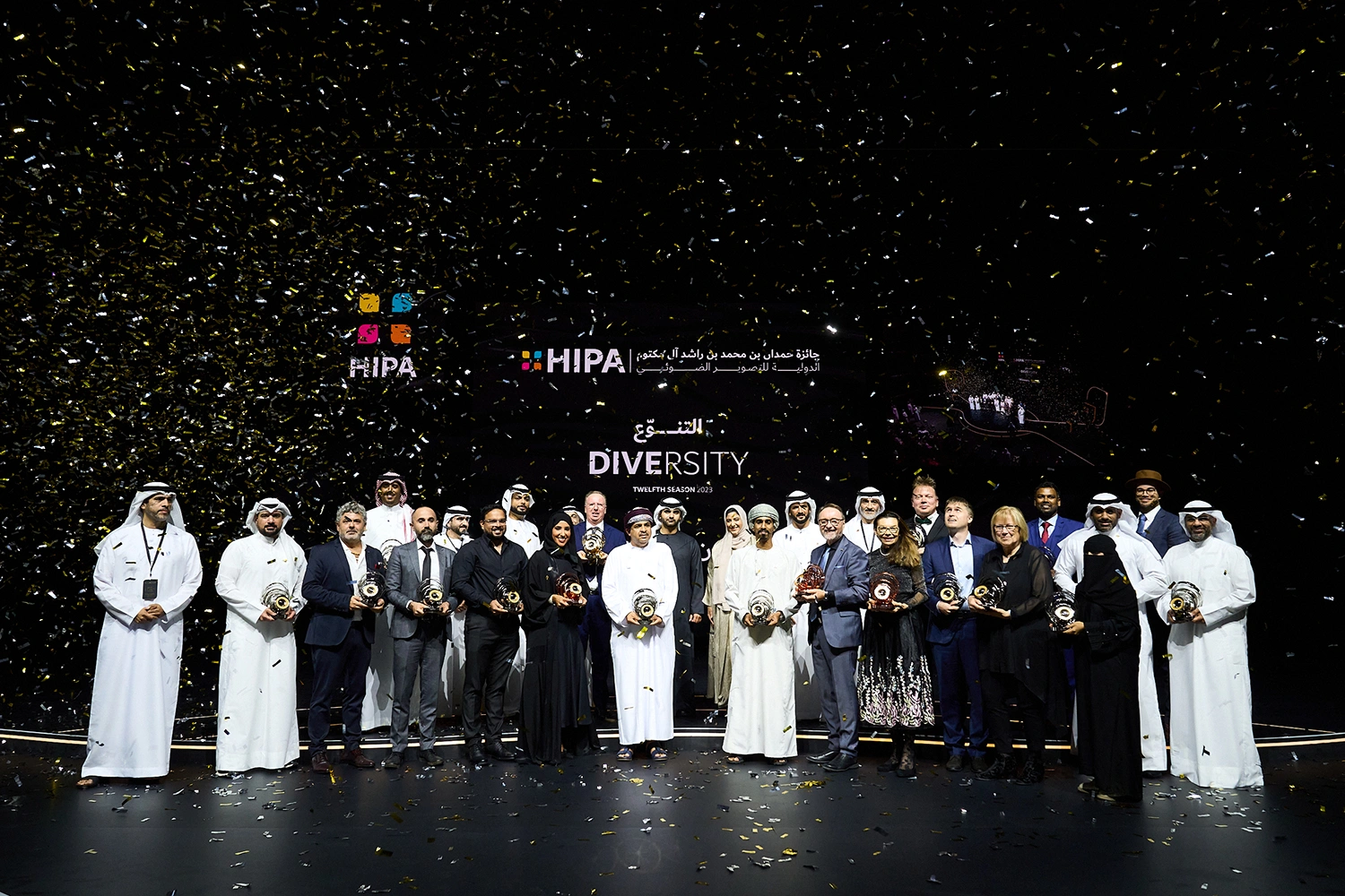 Winning photographers receiving awards on stage during international ceremony in Dubai