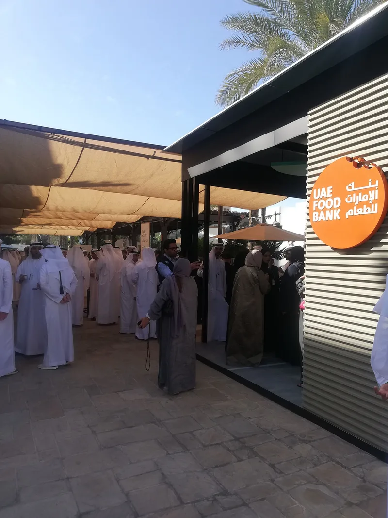 Presenter speaking inside the UAE Food Bank exhibition designed by Evolution Events