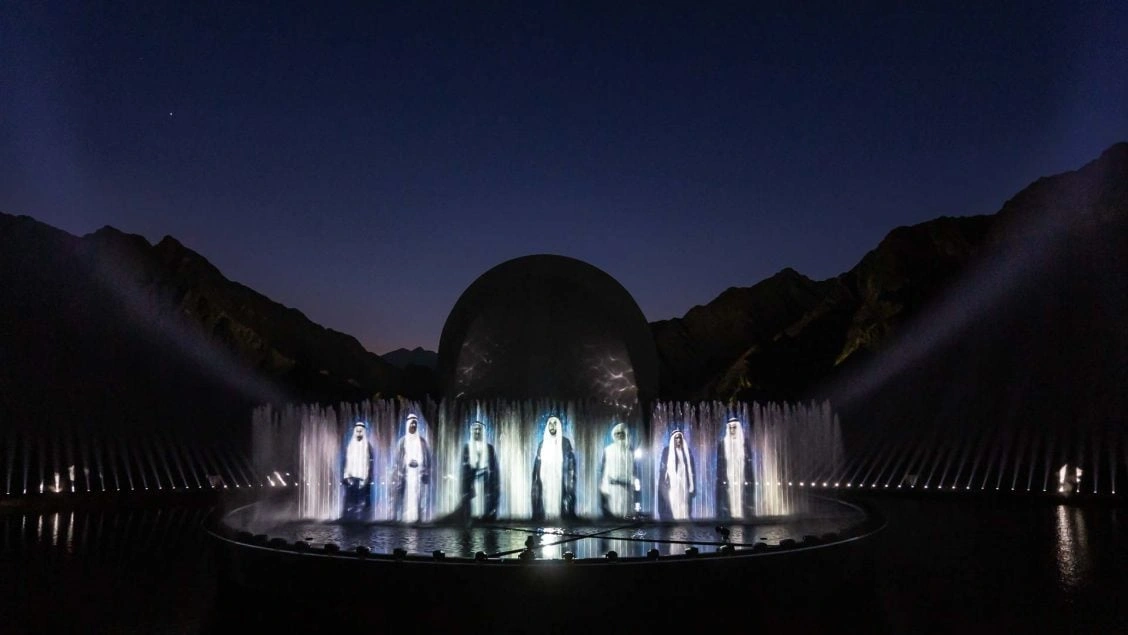 Massive curved water screen projection system displaying historical UAE documentary visuals