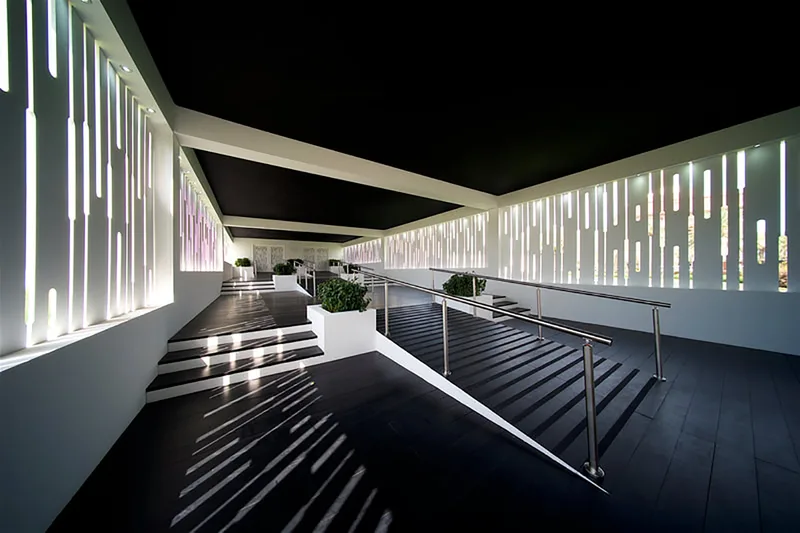 Outdoor networking terrace with weather-resistant timber standing tables and ambient lanterns
