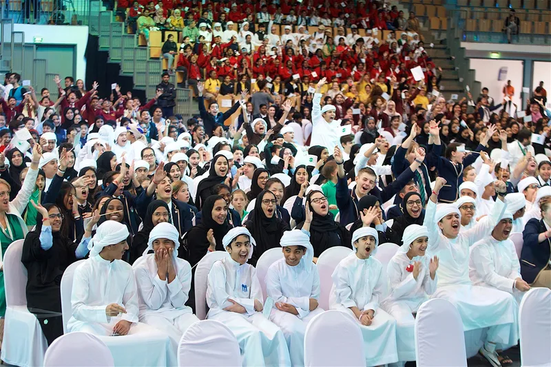 Student leaders and international youth envoys gathering along rally stage in Abu Dhabi